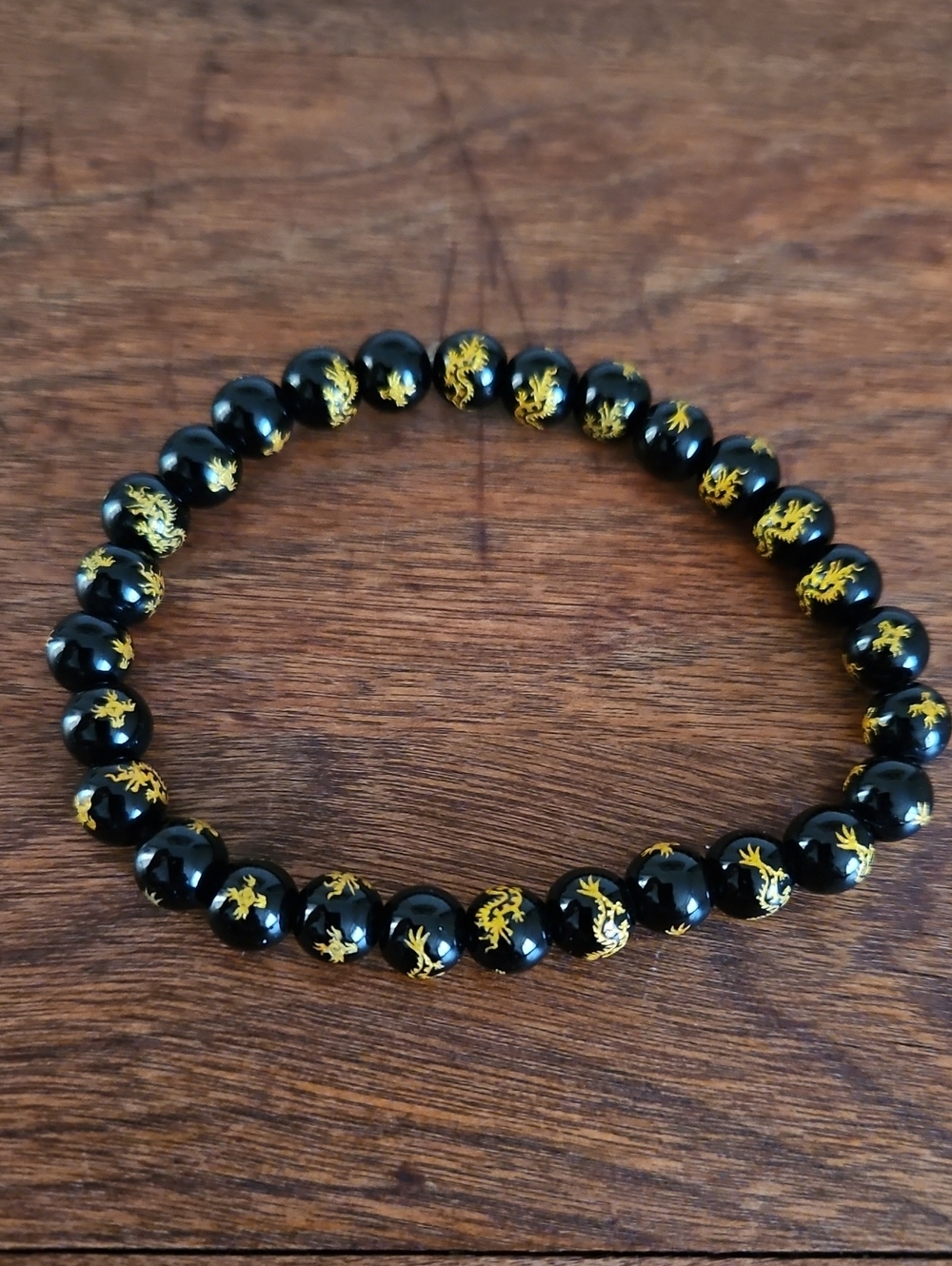Black Beaded Bracelet with Gold Dragon Motif